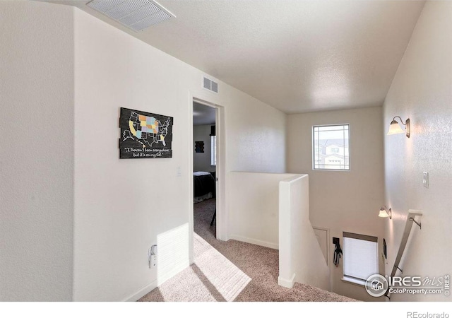 bathroom featuring baseboards, visible vents, and a textured ceiling