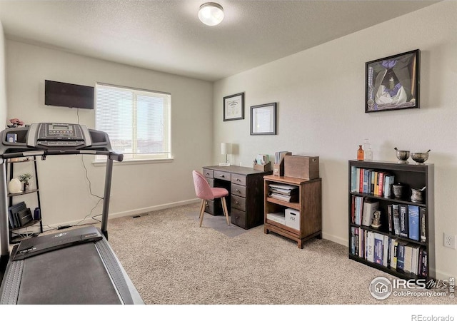 home office with carpet, baseboards, and a textured ceiling