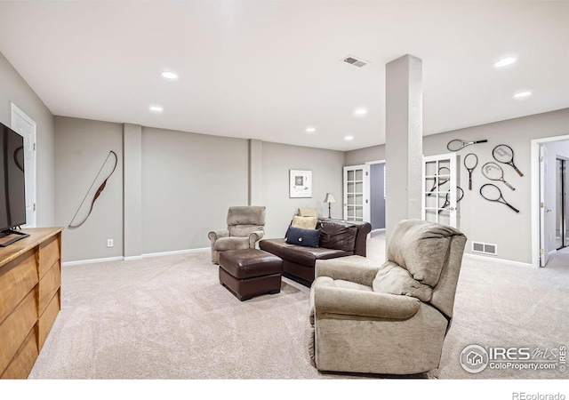 living area with carpet floors, recessed lighting, visible vents, and baseboards