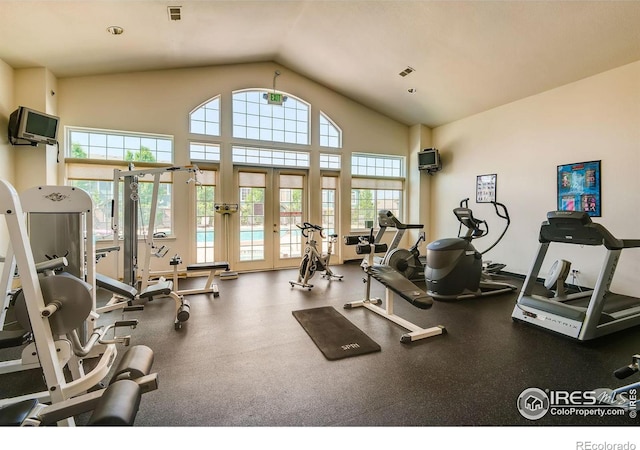 gym featuring high vaulted ceiling, visible vents, and french doors