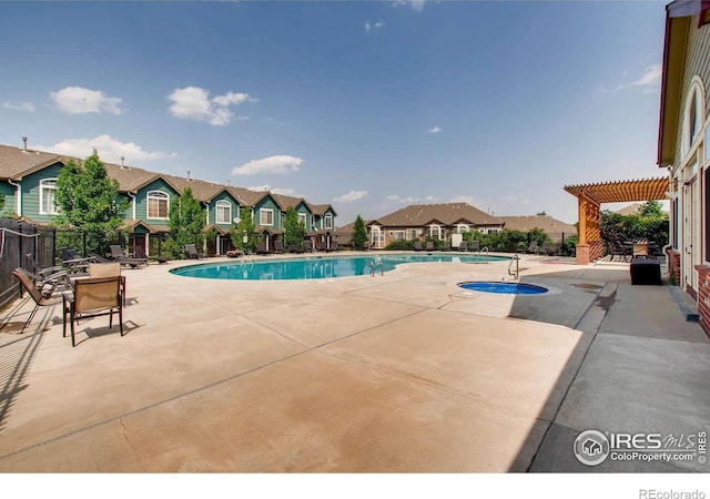 community pool featuring a residential view, a patio area, fence, and a pergola