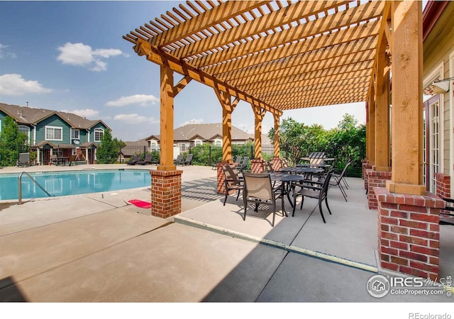 community pool with a patio, fence, a residential view, and a pergola