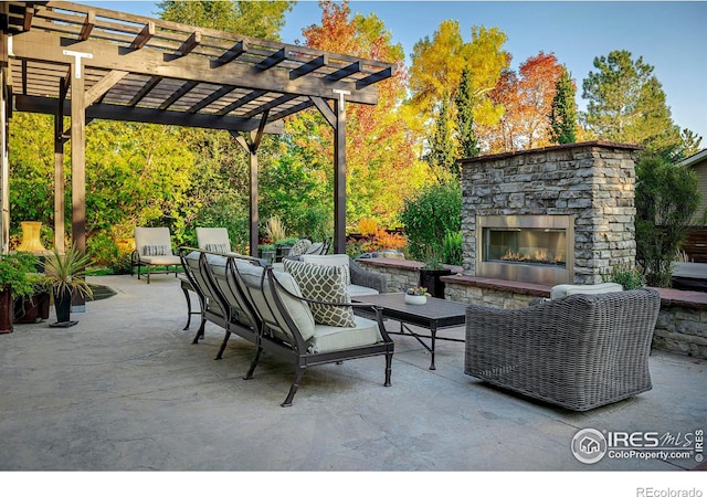 view of patio / terrace with an outdoor living space with a fireplace