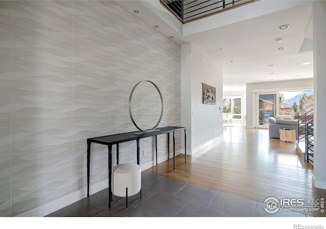 hallway featuring recessed lighting, visible vents, baseboards, and tile patterned floors