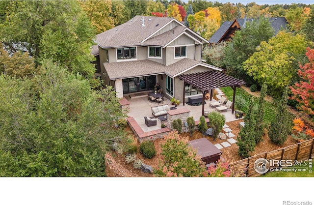 rear view of house featuring an outdoor hangout area, a shingled roof, fence, board and batten siding, and a patio area