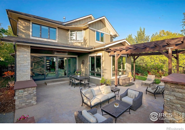 back of house with outdoor lounge area, board and batten siding, a patio area, and a pergola