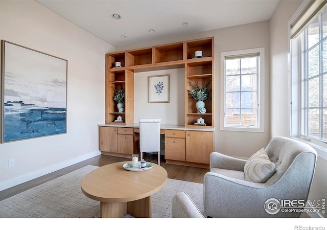 living area featuring dark wood-style floors, recessed lighting, built in study area, and baseboards