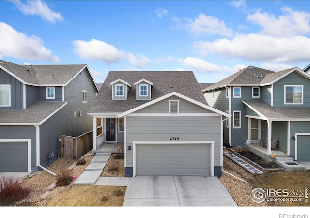 view of front of home featuring a garage, concrete driveway, and roof with shingles