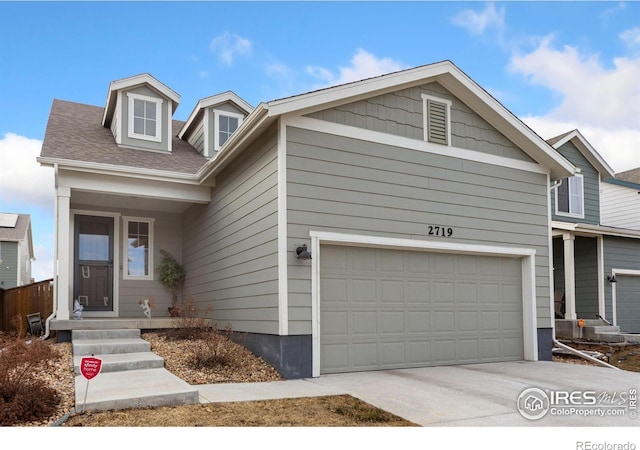 view of front of property with concrete driveway and an attached garage