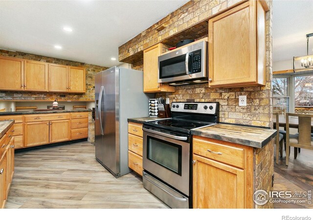 kitchen featuring appliances with stainless steel finishes, dark countertops, recessed lighting, and tasteful backsplash