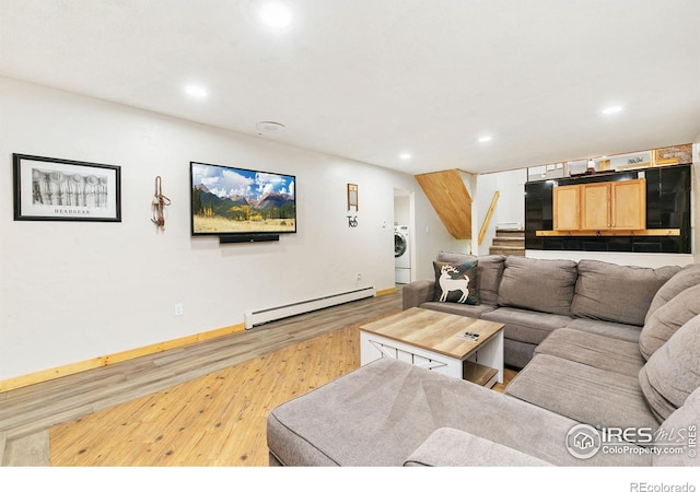 living room featuring a baseboard radiator, stairway, washer / clothes dryer, wood finished floors, and recessed lighting