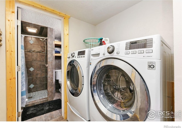 washroom featuring washing machine and dryer and laundry area