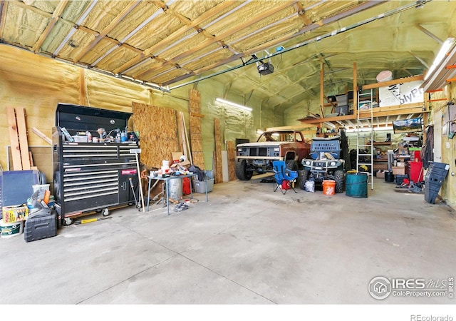 garage with a workshop area and a garage door opener