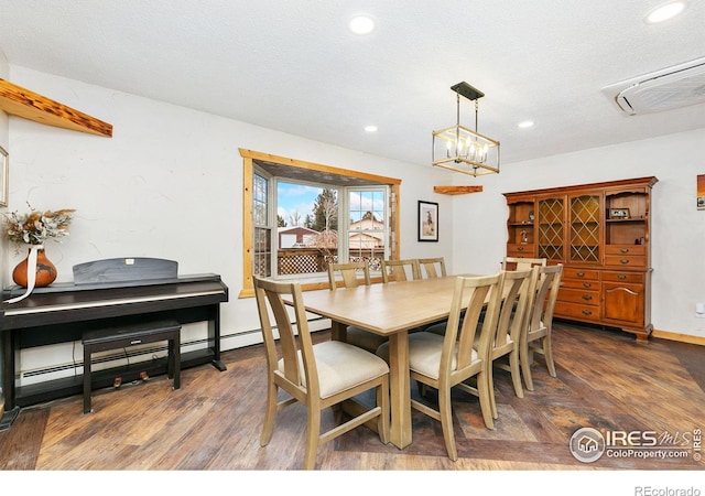 dining room with recessed lighting, a wall mounted AC, dark wood-type flooring, a textured ceiling, and baseboards