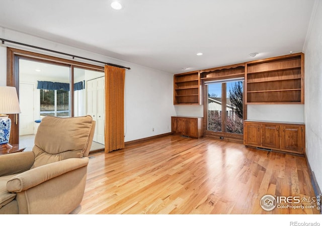 unfurnished living room with light wood-style floors, baseboards, and recessed lighting