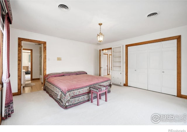 bedroom with light carpet, visible vents, and a closet