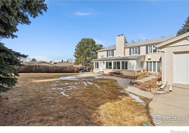 rear view of property with a chimney