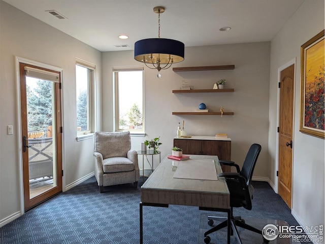 office featuring dark colored carpet, visible vents, and baseboards