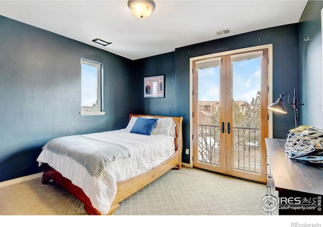 bedroom with access to exterior, carpet, visible vents, and french doors