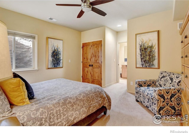 bedroom with baseboards, a ceiling fan, visible vents, and light colored carpet