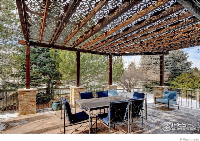 view of patio featuring outdoor dining space and a pergola