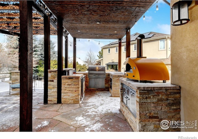 view of patio / terrace featuring exterior kitchen, grilling area, and a sink