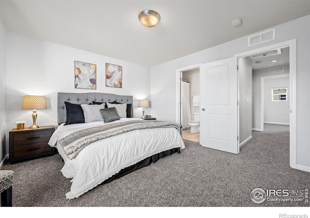 carpeted bedroom with baseboards, visible vents, and ensuite bath