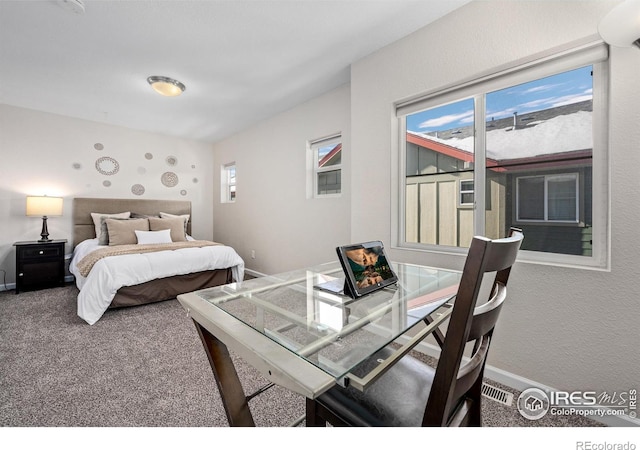 carpeted bedroom featuring baseboards