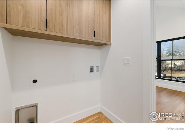 510 Wood St, Fort Collins, CO 80521 - clothes washing area with cabinet space, light wood finished floors, baseboards, hookup for a washing machine, and hookup for an electric dryer