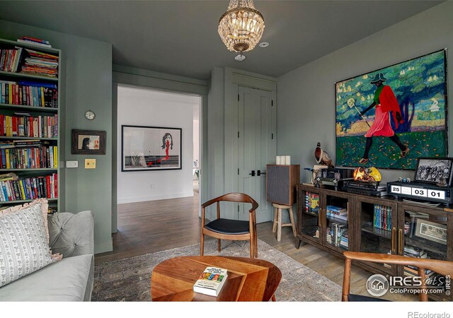 living room featuring a notable chandelier and wood finished floors