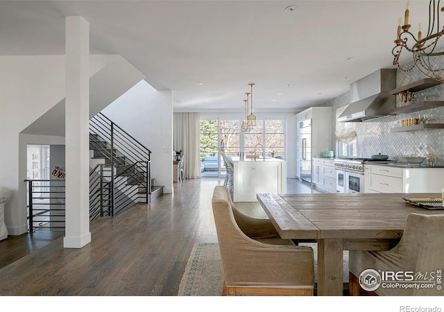 dining room with dark wood-style floors, stairway, and baseboards