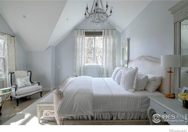 bedroom featuring vaulted ceiling, wood finished floors, and an inviting chandelier