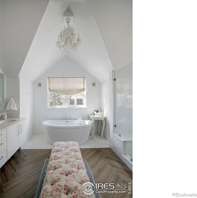 full bathroom featuring lofted ceiling, a soaking tub, vanity, and a shower stall