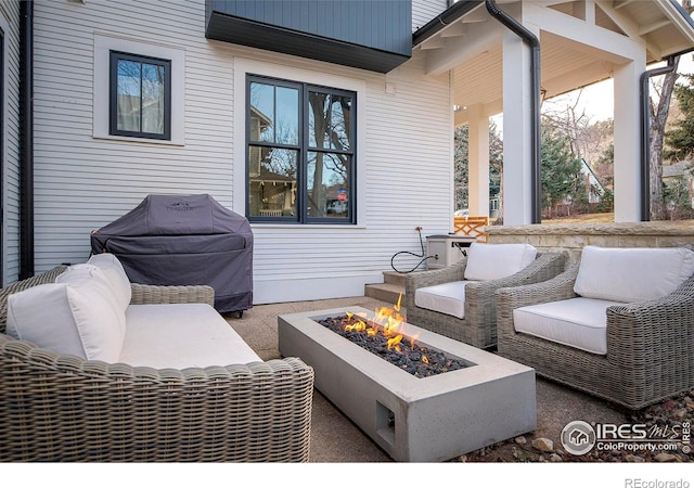 view of patio featuring an outdoor living space with a fire pit