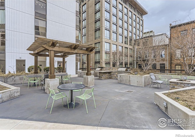 exterior space featuring a grill, a pergola, and exterior kitchen