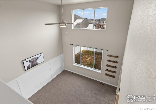 empty room featuring carpet and ceiling fan