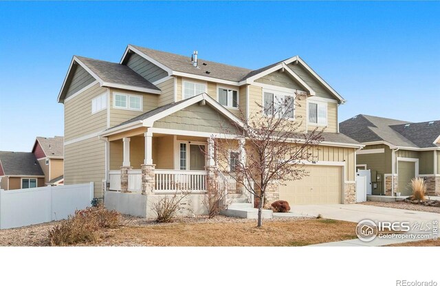 craftsman inspired home with fence, board and batten siding, covered porch, concrete driveway, and a garage