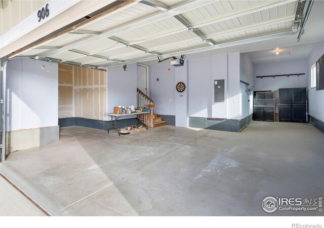 garage featuring electric panel and a garage door opener