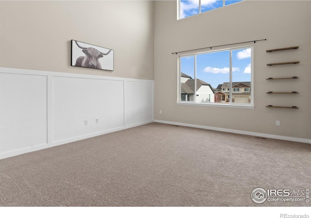 empty room featuring plenty of natural light and carpet