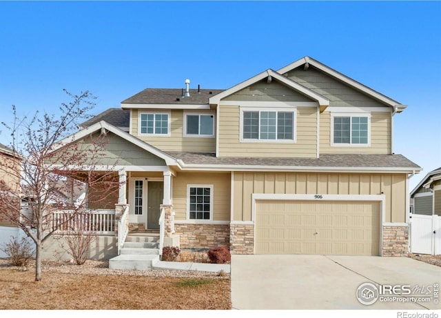 craftsman inspired home with a garage, board and batten siding, a porch, and driveway