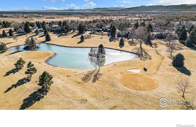 birds eye view of property with a water and mountain view