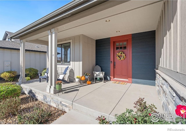 view of exterior entry with covered porch