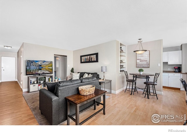 living area with baseboards and light wood-style floors