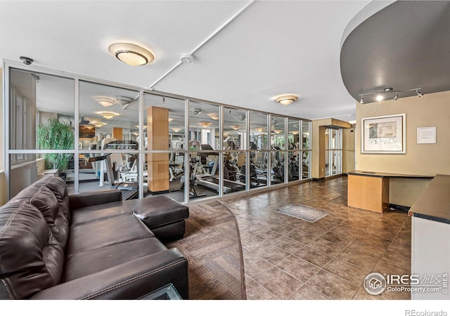 exercise room with a wall of windows, plenty of natural light, and tile patterned floors