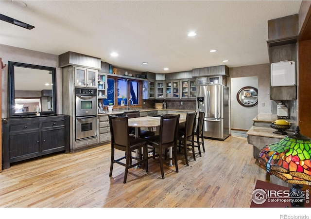 dining area featuring recessed lighting and light wood-style floors