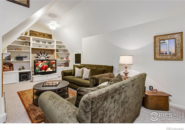 living area featuring lofted ceiling, carpet flooring, and baseboards