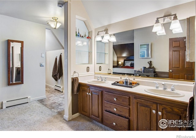 full bathroom featuring double vanity, a baseboard radiator, baseboard heating, vaulted ceiling, and a sink