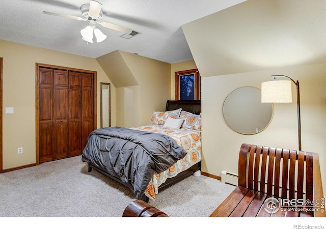 carpeted bedroom featuring baseboards, visible vents, baseboard heating, and a closet