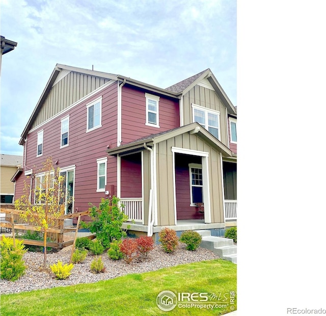 back of property featuring board and batten siding and a porch