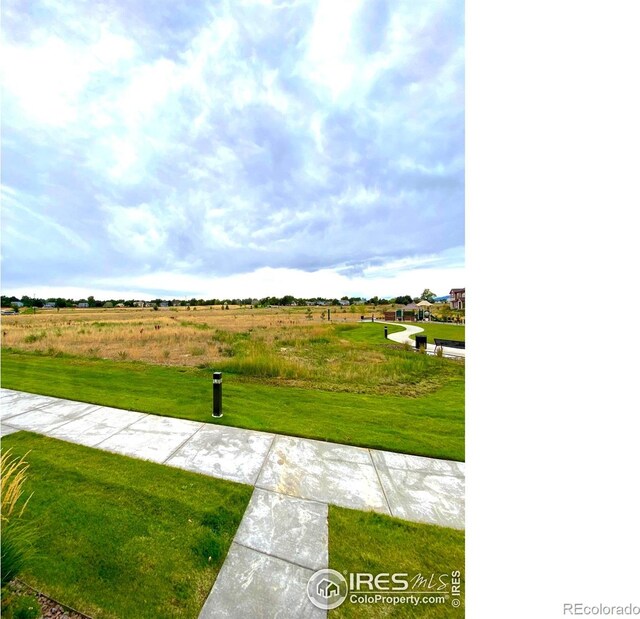 surrounding community featuring a rural view and a lawn